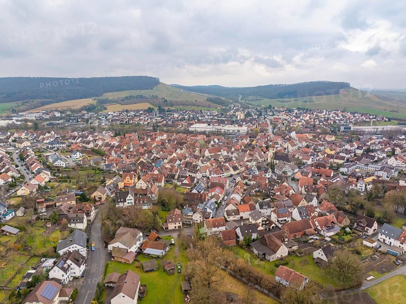 View of urban settlement with red roofs and green hills in the background, Großbottwar, Ludwigsburg district, Baden-Württemberg, Germany