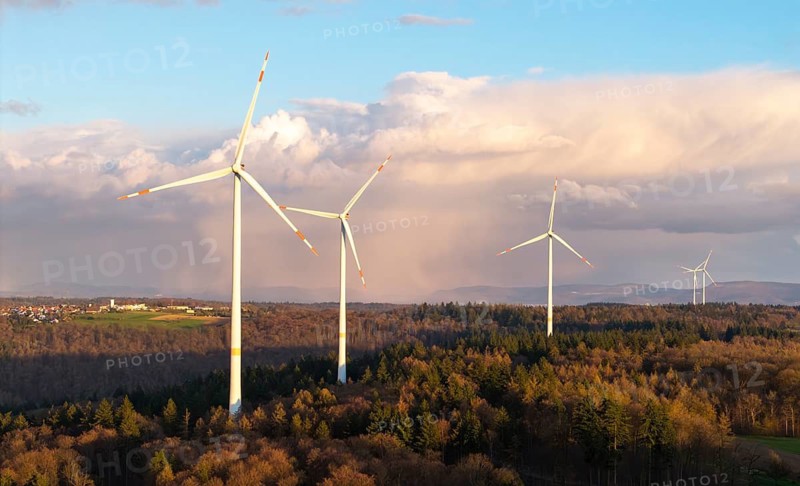 A series of wind turbines in the forest against a dramatic backdrop of clouds in the sky, wind turbine, near Schorndorf-Winterbach, Baden-Württemberg, Germany