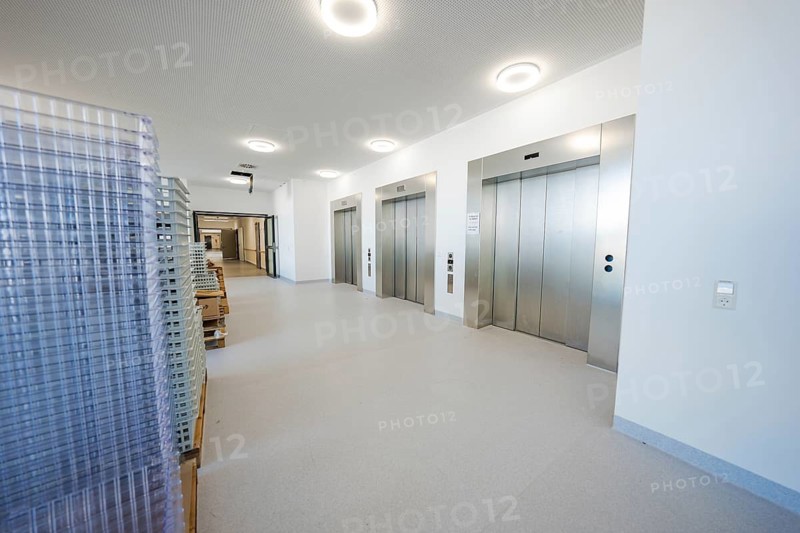 A modern hospital lobby with elevators and transport carts in bright surroundings, new Calw hospital, Germany