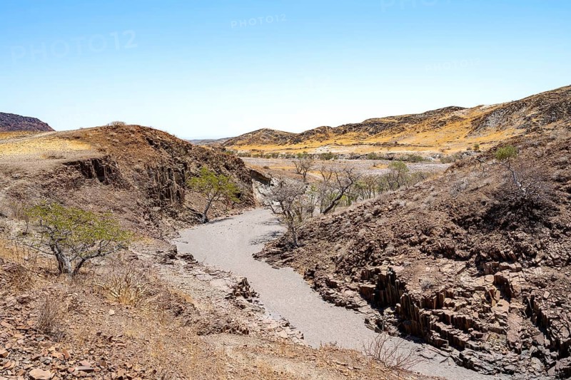 Dry river valley with basalt rocks, rock formation Organ Pipes, Damaraland, Kunene, Namibia
