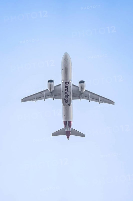 Eurowings aircraft flies past the blue sky, Stuttgart Airport, Germany