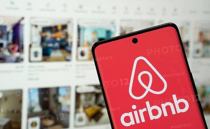 Airbnb logo is seen on a smartphone
