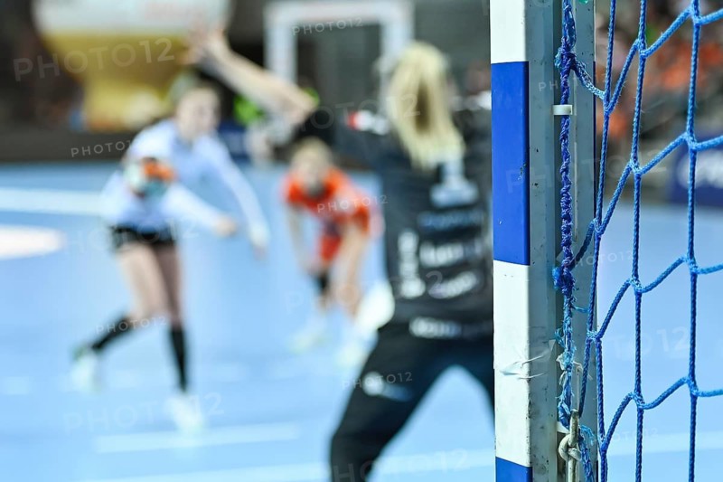 Detail of posta of goal and penalty shot in the background during women handball match.