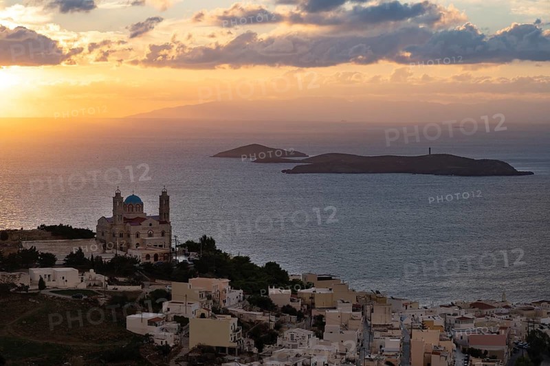 View from Ano Syros to the houses of Ermoupoli with the Anastasi Church or Church of the Resurrection, town view with islands and sea, dramatic cloudy sky at sunrise, Ano Syros, Syros, Cyclades, Greece