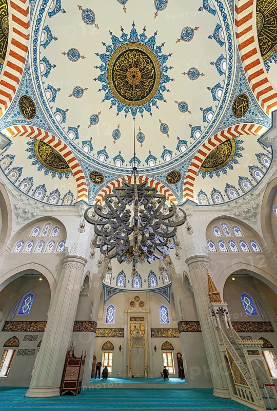 Interior view showcasing the decorated main dome, stained glass windows, a massive chandelier, and the mihrab, Namazgah Mosque, Tirana, Albania