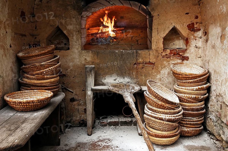 Bread baskets and bread sliders stacked with flour in the bakery, wood-fired fire in the oven, Wildenfels, Upper Franconia, Bavaria, Germany