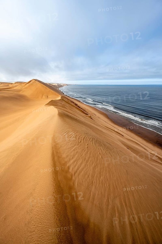 Sand dunes and sea in morning light, Atlantic coast and Namib desert, impressive desert landscape, Sandwich Harbour, Namib Naukluft Park, Namibia