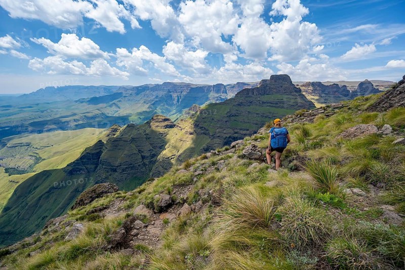 Female mountaineer hiking trail to Cathedral Peak or Cathedralpiek or Mponjwana, Drakensberg, KwaZulu-Natal, South Africa
