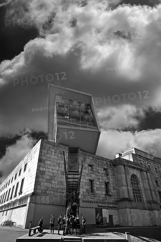 Modern entrance to the documentation center, Reichsparteitagsgelände 1933-1945, former Congress Hall of the NSDAP, a group of students waiting in front, cloudy sky, black and white, Bayernstraße 110, Nuremberg, Middle Franconia, Bavaria, Germany