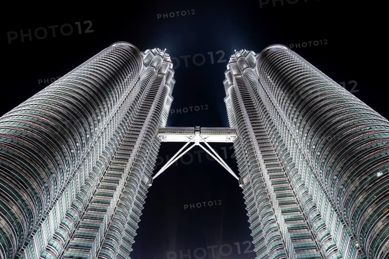 Petronas Towers, KLCC Twin Towers, interlinked 88-storey supertall twin skyscrapers illuminated at night in capital city Kuala Lumpur, Malaysia
