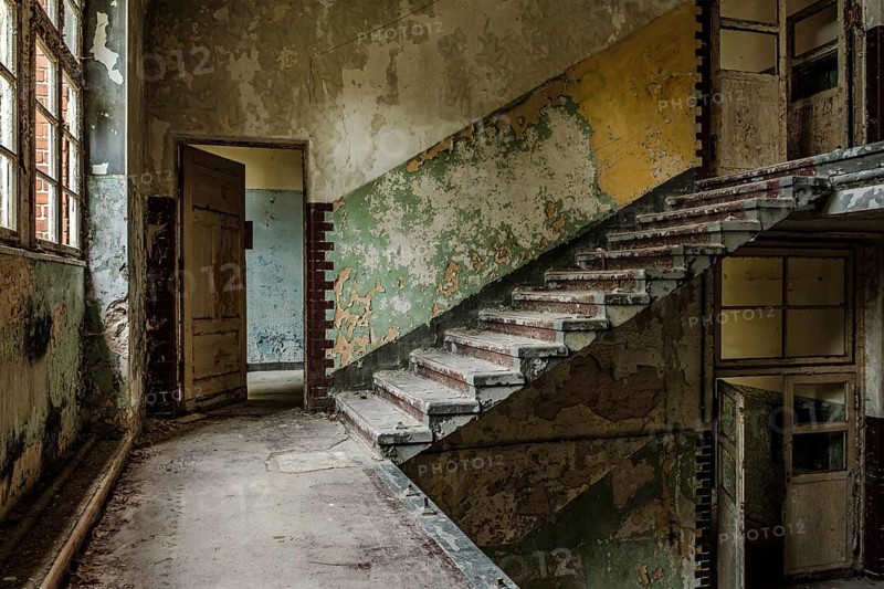 Mysterious bare staircase in a building in the complex of the former Pulmonary Hospital and Lost Place Heilstätte Grabowsee, Oranienburg, Brandenburg, Germany
