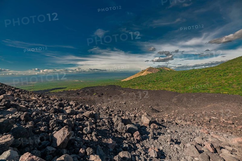 Beautiful view of a vegetated hill surrounded by volcanic rocks. Panoramic view from Cerro Negro, Nicaragua