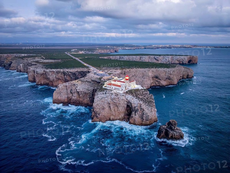 Drone view of the Lighthouse of Cabo de Sao Vicente in Sagres, Algarve, Portugal, at evening with ocean texture and Atlantic ocean