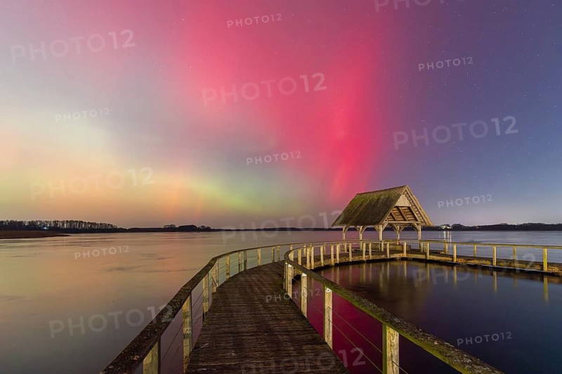 Wooden jetty and Northern Lights, Aurora borealis, polar lights over Lake Hemmelsdorf, Hemmelsdorfer See near Lübeck, Schleswig-Holstein, Germany