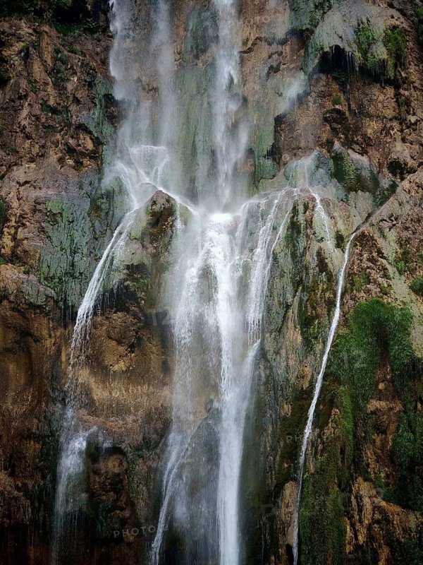 Majestic waterfalls fall over moss-covered rocks, an impressive natural spectacle, Plitvice Lakes National Park, Croatia