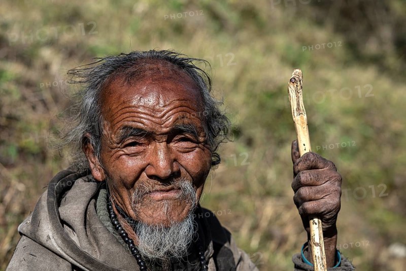 Portrait, elderly Nepalese man, native of the Tsumba Tibetan ethnic group, Tsum Valley, Himalayas, Nepal