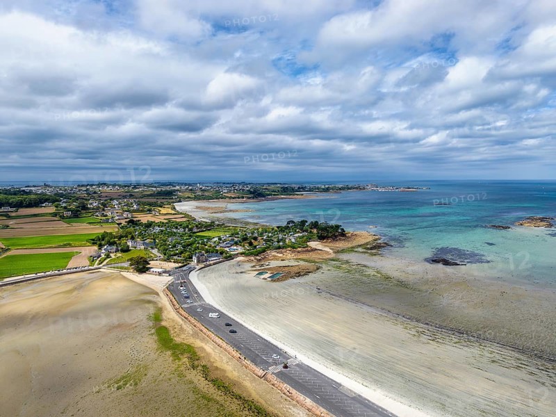Aerial view of the peninsula, Îlot Sainte-Anne and the surrounding Wadden Sea landscape on the Breton coast with shallow sandbanks in turquoise seawater, Saint-Pol-de-Léon, Finistère, Brittany, France