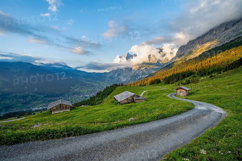 Road, alpine huts and alpine meadows, sunset, summit of the Wetterhorn in the back, Alpiglen, Grindelwald, Bernese Oberland, Switzerland