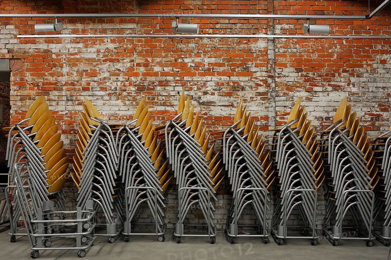 Modern stacking chairs in front of a brick wall, unfinished small hall of the NS Congress Hall from 1943, today the Reichsparteitagsgelände Documentation Center, Bayernstraße 110, Nuremberg, Middle Franconia, Bavaria, Germany