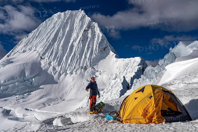High camp with tent and mountaineer, tent camp, high camp at 5500 m above Alpamayao, southwest face, 5947 m, with the title of most beautiful mountain in the world, Cordillera Blanca, Huascaran National Park, northern Peru, Peru, South America