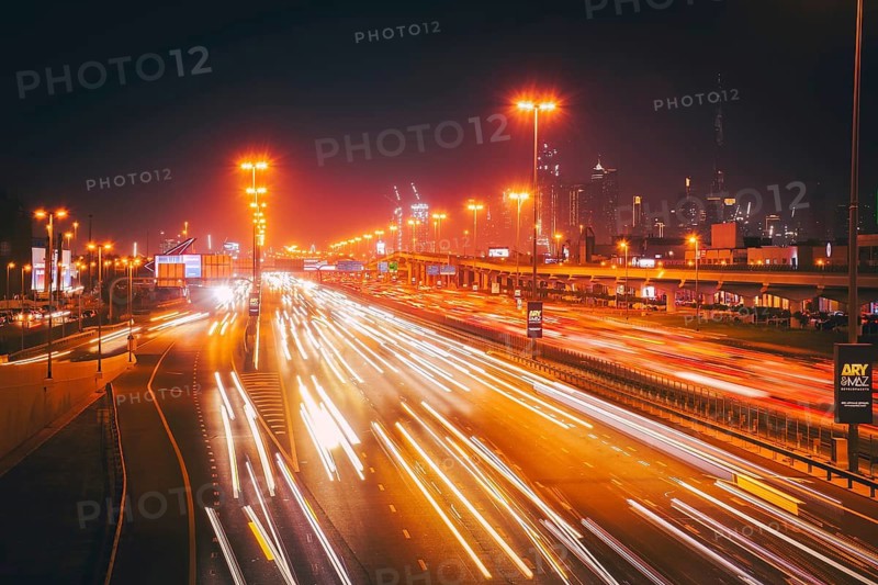 Panorama Dubai heavy night night traffic on Sheikh Zayed Road after work rush hour traffic. Light trails lead to the Burj Khalifa and Downtown Dubai cityscape at night landmarks skyline