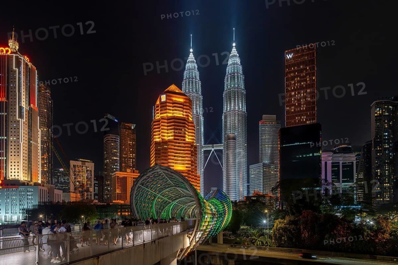 Saloma Link, Petronas Towers, KLCC Twin Towers and skyscrapers illuminated at night in capital city Kuala Lumpur, Malaysia