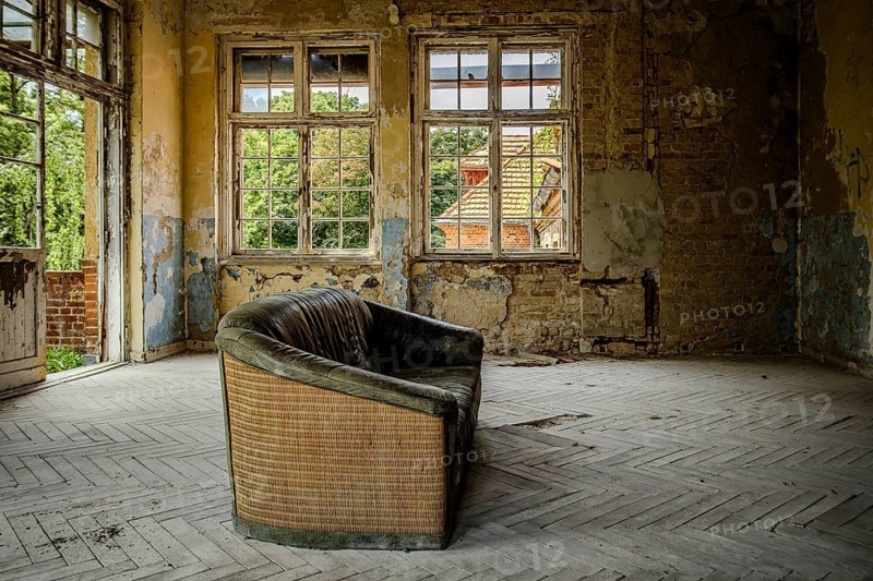 Vacant sofa in the so-called Saal des Sofas, former lung sanatorium and lost place Heilstätte Grabowsee, Oranienburg, Brandenburg, Germany