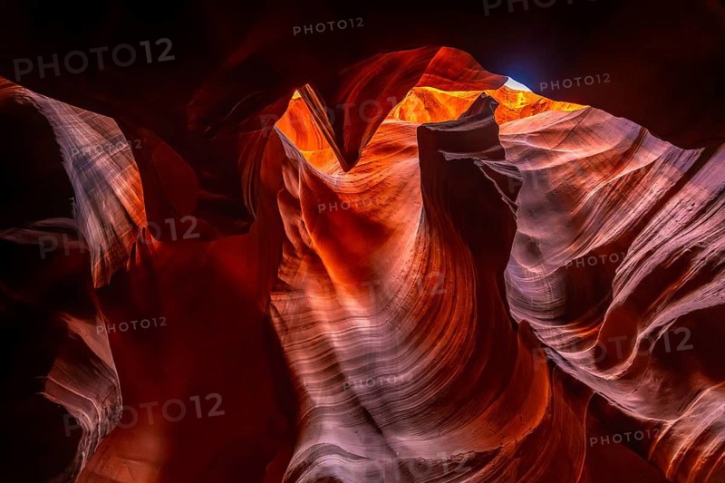 Antelope canyon's upper slot revealing warm orange and red sandstone formations sculpted by water and wind erosion, creating beautiful smooth wave like patterns