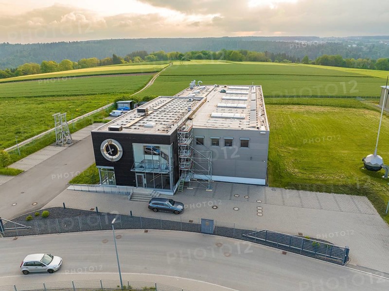 Industrial building on a green field, with a road in the foreground, shipping, Neckar, Wilhelma, Stuttgart, Germany