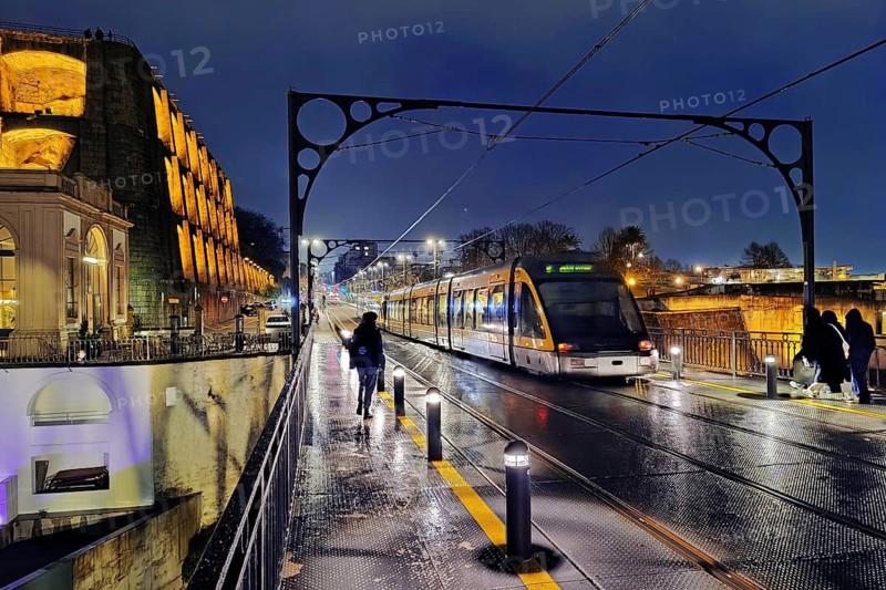 Metro on the Ponte Dom Luis I arched bridge looking towards Vila Nova de Gaia on a rain-wet night, Porto, Portugal