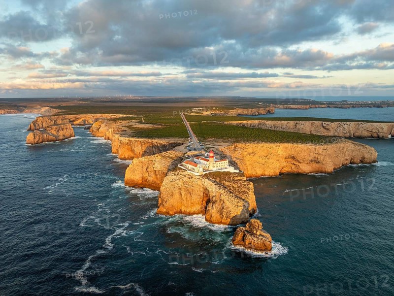 Drone view of the Lighthouse of Cabo de Sao Vicente in Sagres, Algarve, Portugal, at sunset with tower light and Atlantic ocean