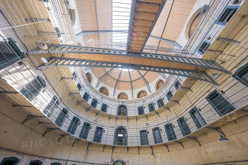 Interior view of a round part of a building with detailed metal structures and window openings, Kilmainham Gaol prison, Dublin, Ireland