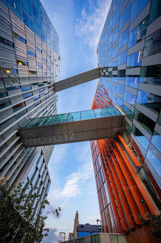 Architectural masterpiece with glass buildings from Google connected by bridges, below a blue sky, Docklands Dublin, Ireland