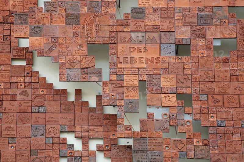 Art installation Tree of Life made of many small different tiles, various red monochrome tiles, inscription, wall mosaic, puzzle, modern art, abstract art, main post office, street art, August-Bebel-Platz