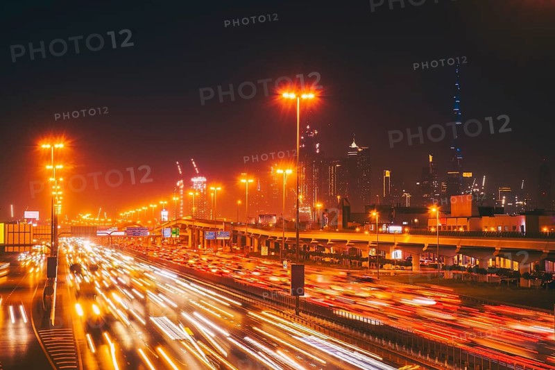 Panorama Dubai heavy night night traffic on Sheikh Zayed Road after work rush hour traffic. Light trails lead to the Burj Khalifa and Downtown Dubai cityscape at night landmarks skyline