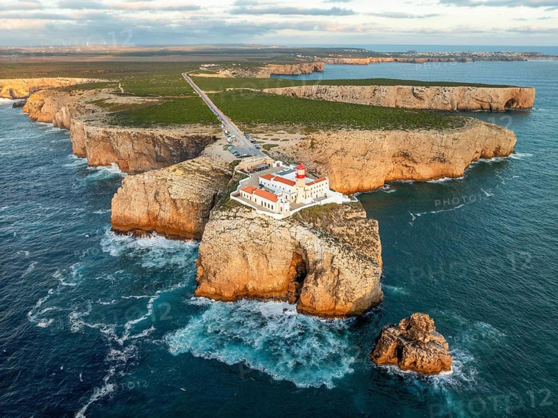 Drone view of the Lighthouse of Cabo de Sao Vicente in Sagres, Algarve, Portugal, at sunset with open ocean and Atlantic ocean
