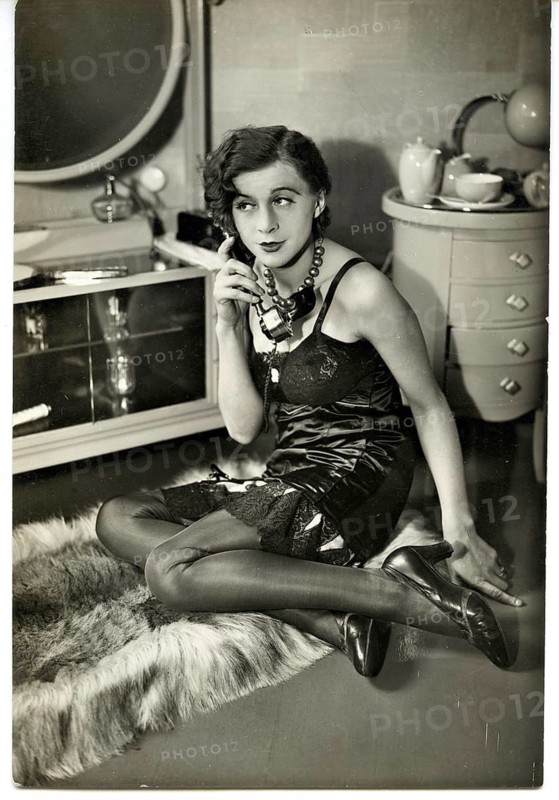 Modern woman, flapper, girl, petticoat, silk stockings, fetishes, twenties, telephone, glamorously dressed woman talking on a fur rug in an elegant room, black and white, around 1928