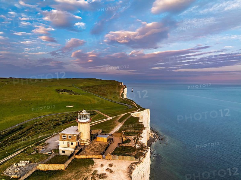 Sunset over Belle Tout Lighthouse from a drone, English Channel, Beachy Head Cliffs, East Sussex, England, United Kingdom
