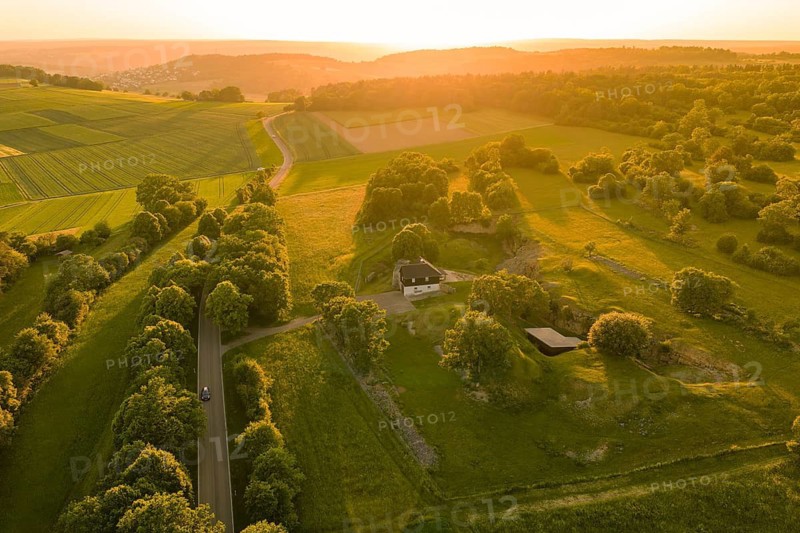 Path and buildings in picturesque landscape, illuminated by the low sun, Gechingen, Hecken and Gäu region, Landreis Calw, Germany