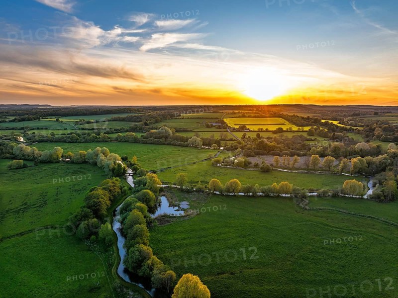 Sunset of Fields and Farms over Horsebridge nad Stockbridge from a drone, Hampshire, England, United Kingdom