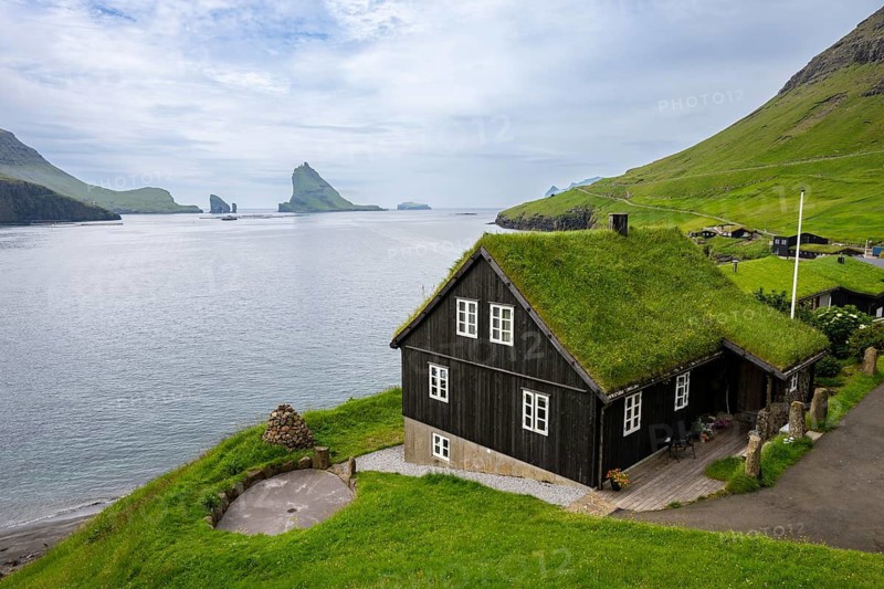 Traditional house with grass roof in the village of Bøur, Tindhólmur and Drangarnir, Vágar Island, Faroe Islands, Denmark