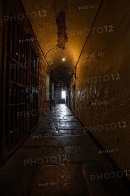 Long, dark prison corridor with stone vaulting, leading into light, Kilmainham Gaol Prison, Dublin, Ireland