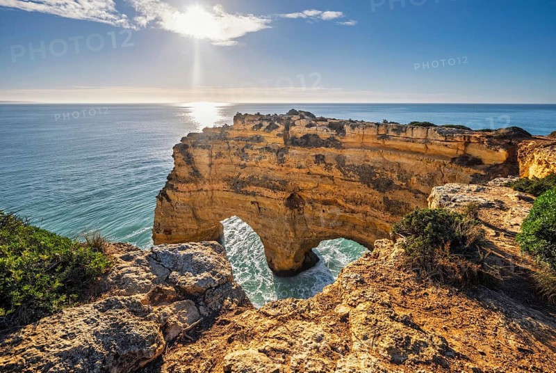 View of Praia da Marinha beach in Algarve, Portugal, with ocean cliffs, sea stacks and natural arch formations