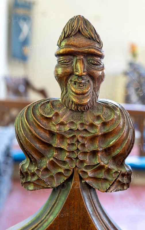 Carved wooden poppyhead face of man with beard, village parish church of Saint Andrew, Winston, Suffolk, England, UK