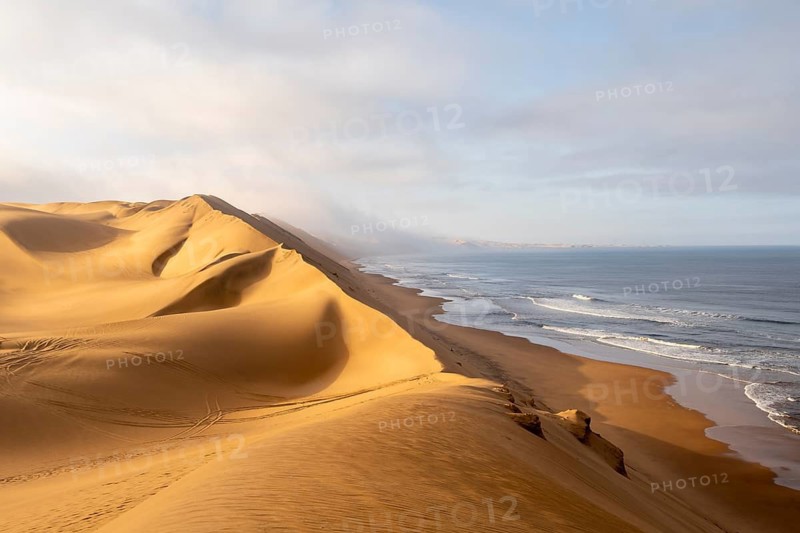 Sand dunes and sea, Atlantic coast and sandy desert with sea of dunes, Sandwich Harbour, Namib Naukluft Park, Namib Desert, Namibia