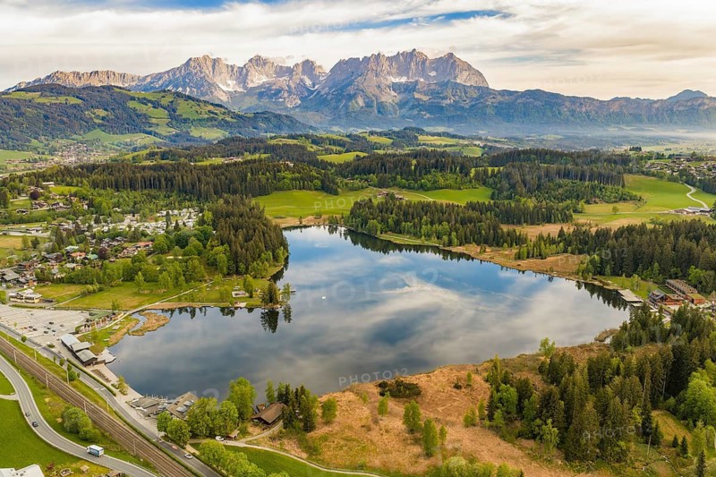 Idyllic panoramic landscape with lake, forests and mountains in the background, Schwarzsee circular trail, Kitzbühel, Austria