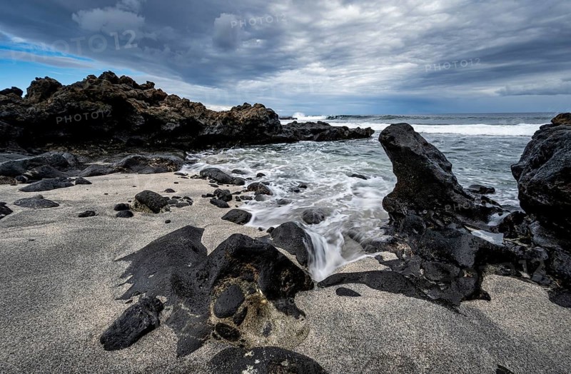 Waves blaze on the beach, rocky coast with volcanic stones, long exposure, Playa de la Pequeña, Punta Usaje, Lanzarote, Canary Islands, Spain