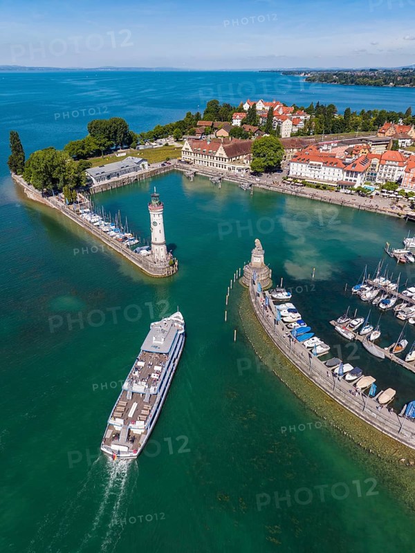 Aerial view of the island of Lindau in Lake Constance with the lighthouse, the Bavarian lions and the incoming passenger ship, sightseeing ship MS Munich of the white fleet, Lake Constance-Schifffahrt, BSB at the port entrance, Swabia, Bavaria, Germany