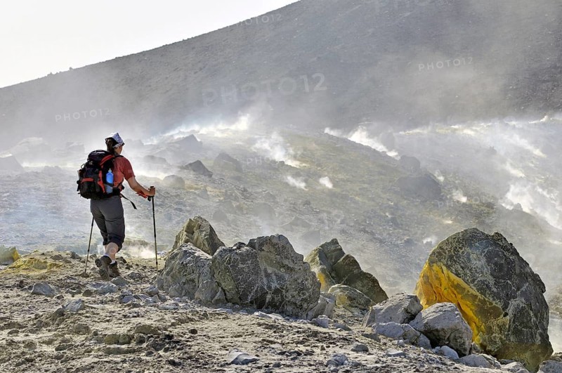Woman wandering through sulfur vapors and volcanic rocks, Vulcano Island, Aeolian or Lipari Islands, Sicily, Southern Italy, Italy