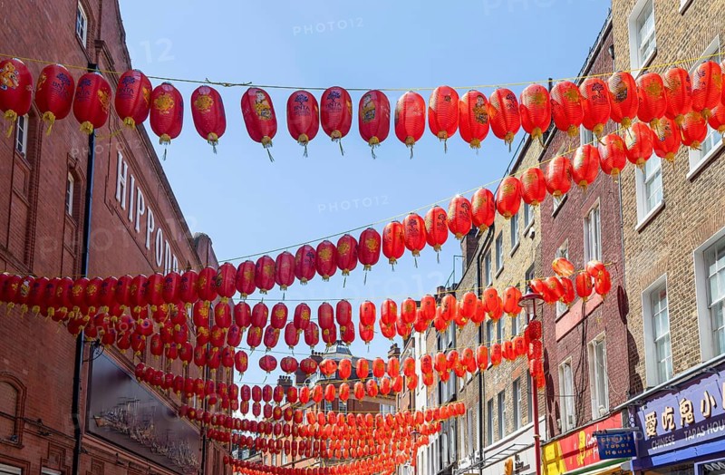 Red Chinese lanterns suspended over street in Chinatown, Little Newport Street, Soho, London, England, UK